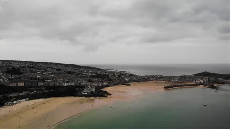 Aerial-panning-right-shot-of-St-Ives-town-and-harbour-on-a-cloudy-day