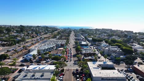 Aerial-drone-shot-over-the-beach-city-of-Encinitas-in-Southern-California,-USA-with-the-view-of-residential-houses,-complexes-and-roads-on-a-sunny-day