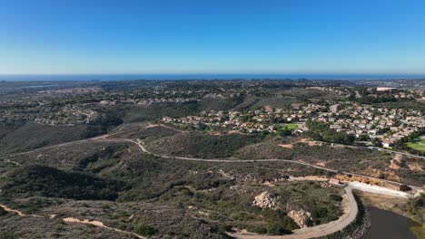 Slow-motion-aerial-drone-shot-of-Calavera-hills-on-a-summer-day-which-offers-6+-miles-of-dirt-biking-and-hiking-trails-at-the-northern-part-of-San-Deigo,-Carlsbad-California