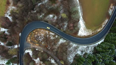 Car-driving-on-a-beautiful-road---top-down-view