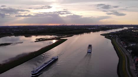 High-Aerial-View-Of-Semper-Fi-Cargo-Vessel-Going-Past-On-River-Noord-Next-To-Crezeepolder-In-Alblasserdam-During-Sunset
