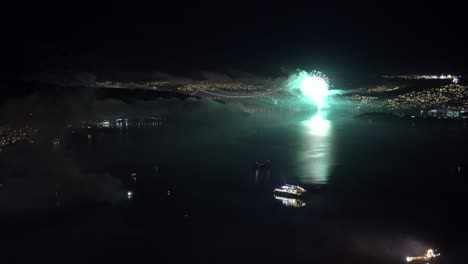 Beautiful-New-year-fireworks-beside-Askoy-bridge-in-Bergen-Norway---Static-midnight-clip-from-mountain-Stoltzen