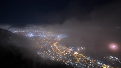 Stunning-Bergen-city-night-timelapse-with-passing-fog-and-cars-in-streets---Static-from-mountain-Stoltzen-with-occasional-fireworks-early-at-new-years-eve