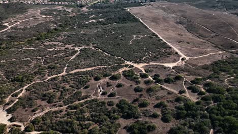 Aerial-drone-slow-motion-view-of-Calavera-hills---a-community-in-Carlsbad-California,-the-northern-part-of-San-Deigo-where-this-area-offers-6+-miles-of-dirt-biking-and-hiking-trails