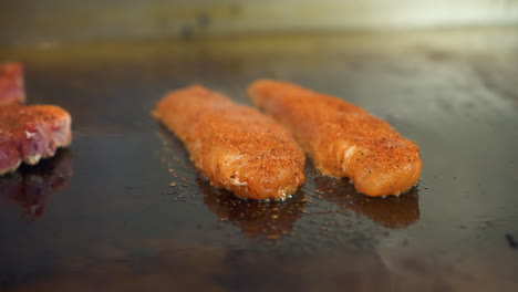 Blackened-catfish-sizzles-and-steams-on-flat-top-griddle,-slider-slow-motion-4K