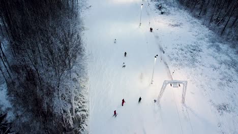 Mountain-skiers-going-downhill-next-to-a-lift-in-Kuutsemäe-in-Estonia