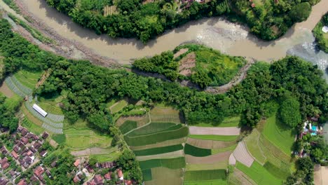 Overhead-aerial-of-neighborhoods-and-woods-by-Progo-River-in-Indonesia
