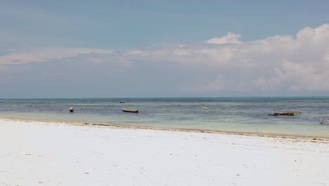 TIME-LAPSE---Boats-and-people-on-the-beach,-Paje,-Zanzibar,-Tanzania,-wide-shot
