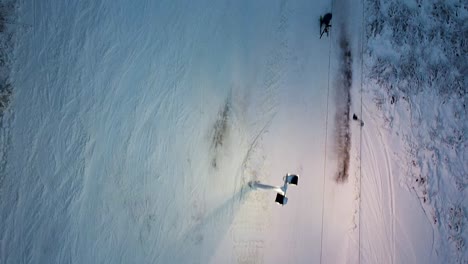 A-top-down-drone-aerial-of-a-ski-lift-in-the-evening