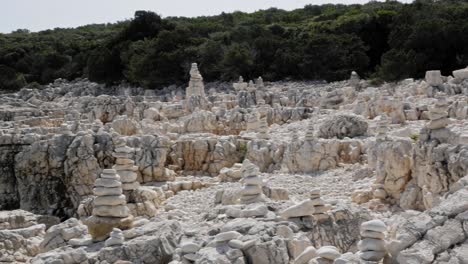 White-Stones-Stacked-In-Unique-Pebble-Beach-Of-Alexia-Near-Paralia-Emplisi,-Greece-