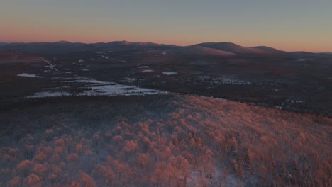 Winter-Landscape-Of-Mountain-Area-With-Dense-Coniferous-Forest-Covered-With-Snow-In-Southern-Quebec-At-Sunset---aerial-drone-shot