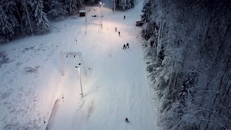 Mountain-skiers-coming-off-the-lift-and-descending-on-a-small-hill-in-Estonia-in-Kuutsemäe