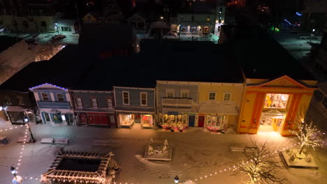 Victorian-storefronts,-homes-with-Christmas-light-decorations-at-night