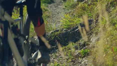 A-mountain-biker-hops-over-a-sharp-rock-in-slow-motion