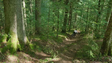 A-mountain-biker-jumps-into-a-steep-gully-with-speed