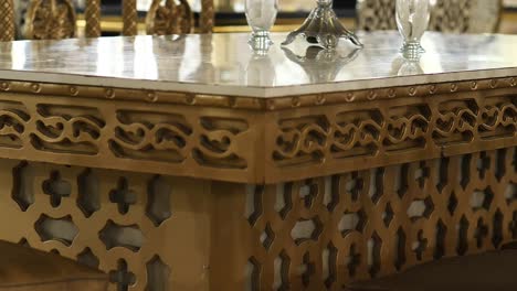 View-Of-Gold-Coloured-Corner-Table-With-Carved-Designs