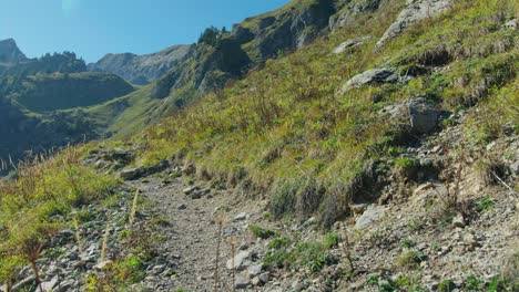A-mountain-biker-rides-an-exposed-alpine-trail