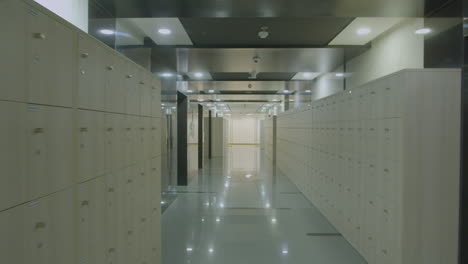 Dolly-In-Shot-Of-a-Locker-Area-In-A-Corridor-Of-A-Modern-Corporate-Office
