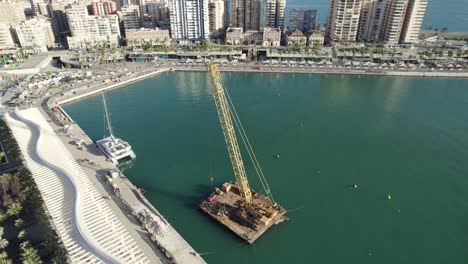 Top-down-view-towards-to-floating-crane-platform-on-Malaga-harbor,-Spain