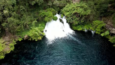 Aerial-orbit-of-a-small-waterfall-hidden-in-the-forest---drone-shot