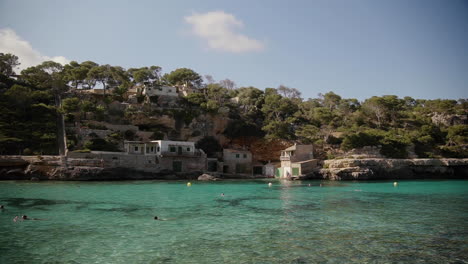People-swim-in-a-turquoise-lagoon-on-the-beautiful-island-of-mallorca