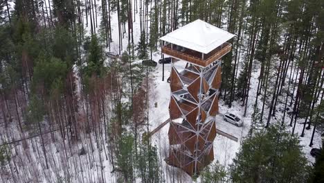Approaching-aerial-drone-view-of-a-viewing-tower-in-a-bog-during-winter