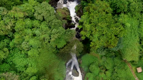 Narrow-waterfall-streams-in-green-Indonesian-forest,-overhead-aerial