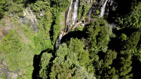 Overhead-view-of-the-waterfall-of-la-niña-encantada-hidden-in-southern-chile---drone-shot