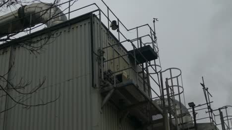 Industrial-warehouse-pipes-steaming-on-roof-cooling-system-vent-pipeline