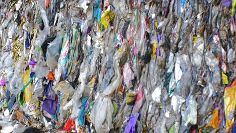 Stack-of-different-types-of-large-garbage-dump,-plastic-bags,-and-landfill-full-of-trash,-environmental-pollution,-medium-shot-rack-focus