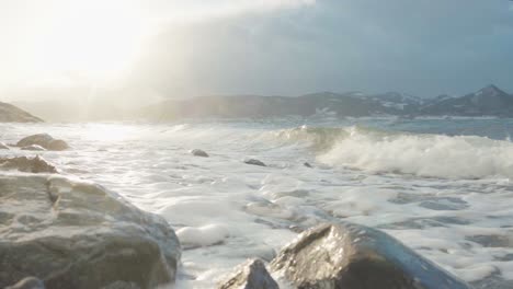 Waves-Crashing-In-Rocky-Shore-During-Sunset-In-Norway---Close-up-shot