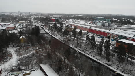 Aerial-view-Trollhättan-waterway-canal-snowy-landscape,-cityscape-surroundings