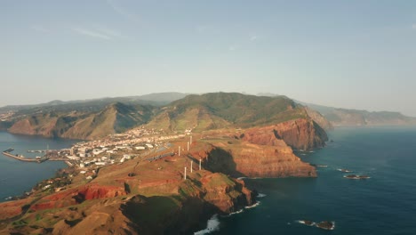 Madeira-island-with-view-of-Caniçal-town-on-rugged-coastline,-aerial