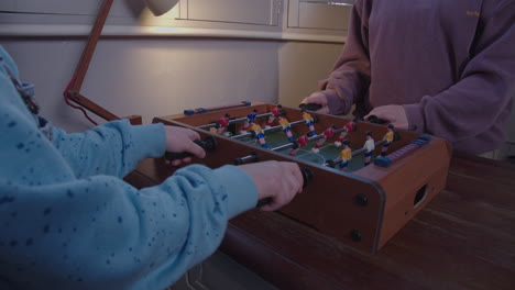Kids-play-miniature-table-football