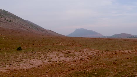 barren-view-of-isolated-rural-remote-area-with-mountain-and-flat-sky