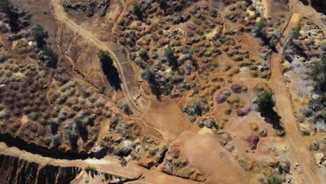 Aerial-view-of-the-colored-rocks-and-terrain-beside-Red-Lake-in-Cyprus,-Greece-near-the-Mitsero-mines