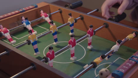 Children-playing-miniature-table-football-game
