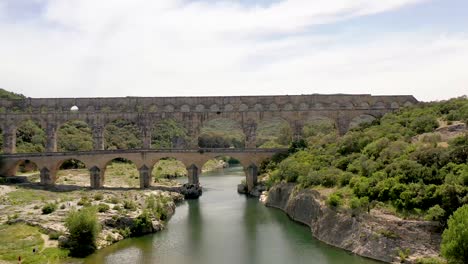 Pont-du-Gard-Roman-aqueduct-bridge-built-in-the-first-century-AD-in-Vers-southern-France,-Aerial-dolly-in-shot