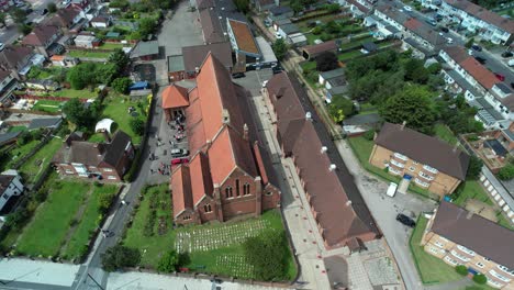 Traditional-church-wedding-ceremony-aerial-orbit-fast-left-above-St-Georges-Enfield-townscape