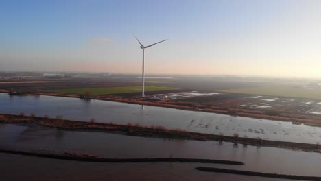 Aerial-View-Of-Lone-New-Giant-Wind-Turbine-Next-To-Oude-Maas-In-Netherlands