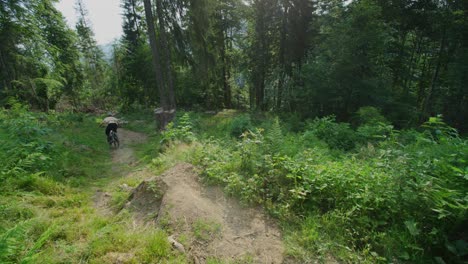 A-mountain-biker-rides-off-a-stump-at-high-speed
