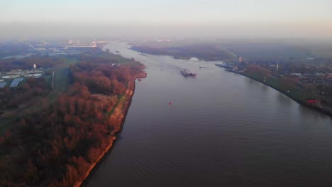 Aerial-Flying-Over-Oude-Maas-Near-Puttershoek-With-Triple-Barge-In-Distance