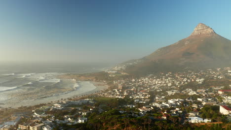 Panoramic-View-Of-Camps-Bay-Beach-Coastal-Town-With-Lion's-Head-Hill-In-Cape-Town,-South-Africa