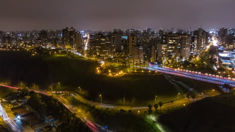 Aerial-hyperlapse-of-Miraflores-city-in-Lima-Peru,-night-drone-view-of-urban-latin-american