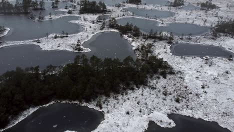 Aerial-drone-view-of-frozen-bog-lakes