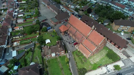 Traditional-church-wedding-ceremony-aerial-orbit-left-view-above-St-Georges-Enfield-townscape