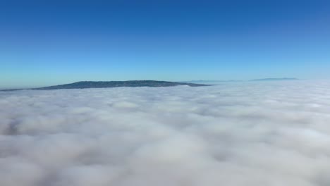 Breathtaking-Panorama-Of-Sea-Of-Clouds-Over-Mountain-Against-Clear-Blue-Sky