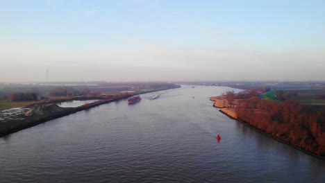 Aerial-Over-Oude-Maas-River-In-Puttershoek-In-The-Moring-With-Boats-In-Distance