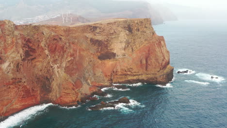 Aerial-View-of-Misty-Coastline-of-Madeira-Island,-Ponta-de-Sao-Lourenco-Steep-Cliffs-Above-Atlantic-Ocean,-Drone-Shot
