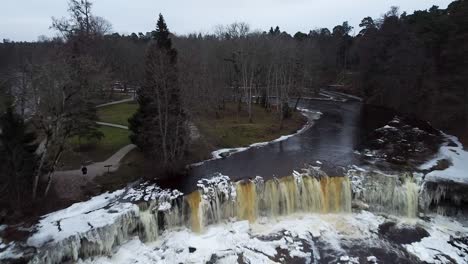 Aerial-drone-view-of-a-frozen-waterfall-in-winter